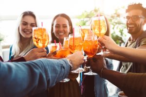 group of happy friends drinking and toasting friends at a bar restaurant 300x200 1 1.jpg